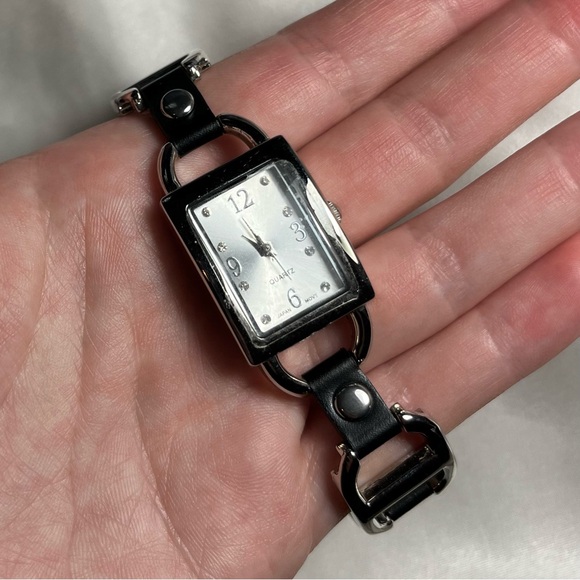 Silver tone buckle watch with black leather style grommets - Picture 2 of 4